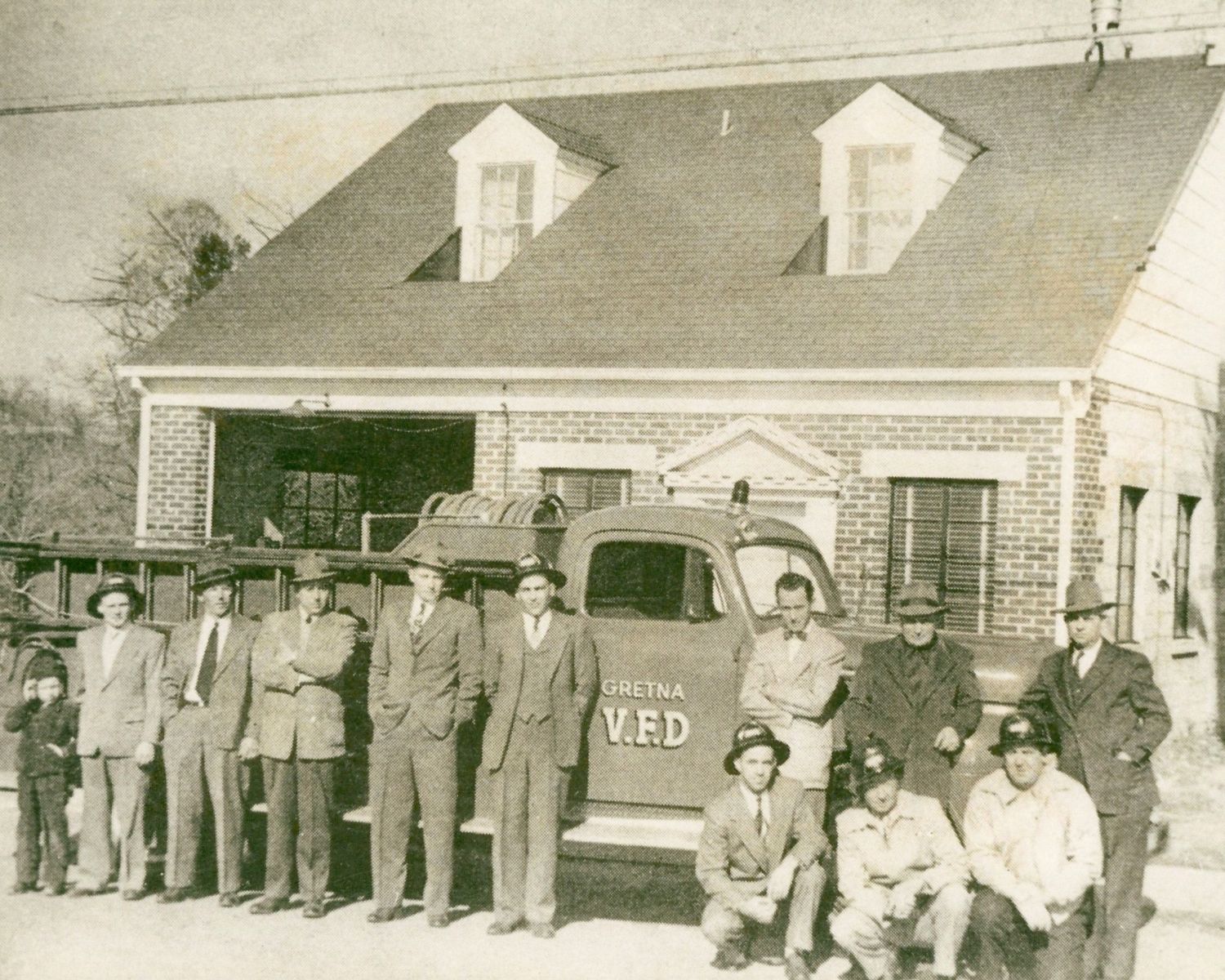 Historic photo of original GVFD members and truck in front of early station