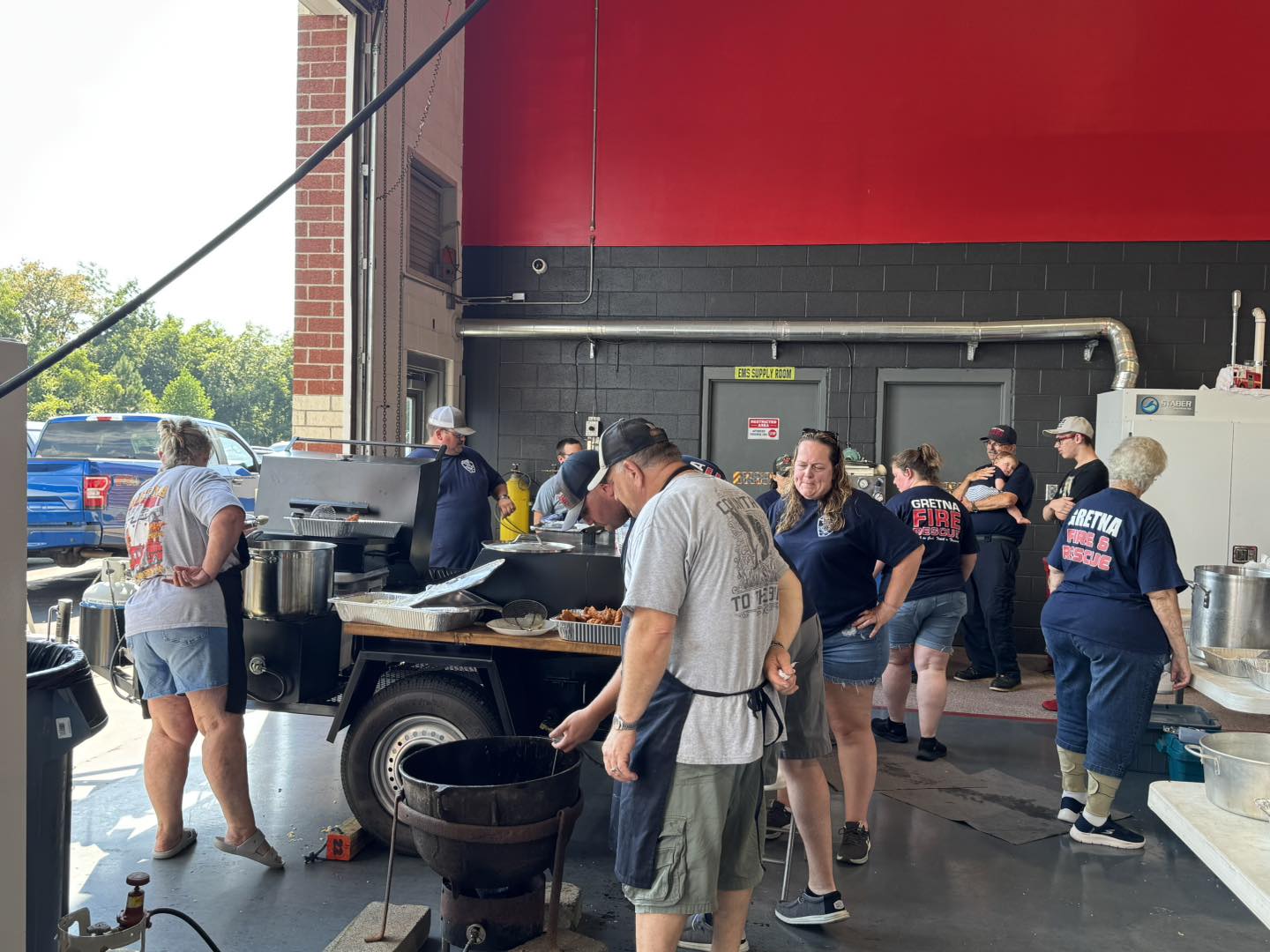 Support volunteers coordinating logistics and community outreach at a station event